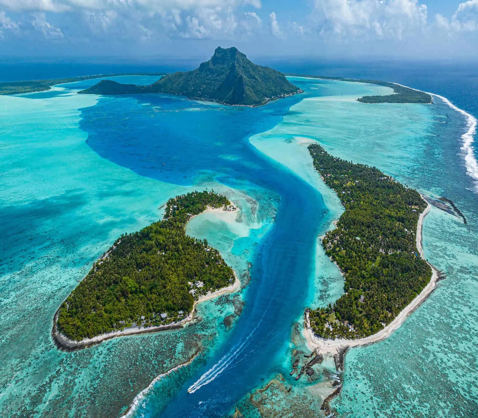 Catamaran anchored in clear French Polynesia lagoon water